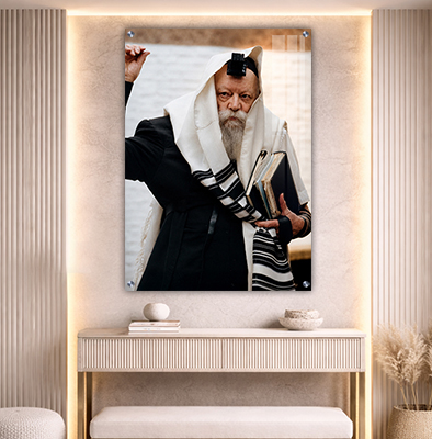 תמונה של הרבי מליובאוויטש אוחז ספרי תורה ומביט הצידה עם טלית ותפילין